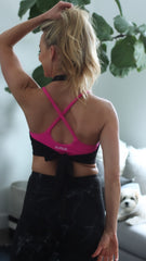 pink battle rope bra and black halter top