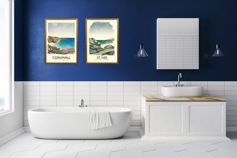 Blue bathroom with a set of two travel art prints of cornwall and the south west