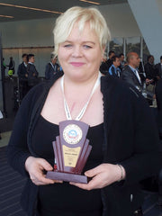 Gudrun Laukka at Inpex 2013 holding Plasterplug award