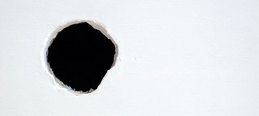 Hole in a white wall