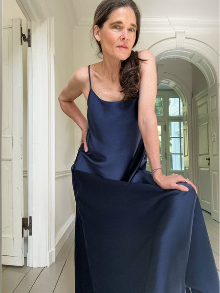 Ann at home in our new slip dress. It has spaghetti straps and is made up in a silky navy charmeuse.