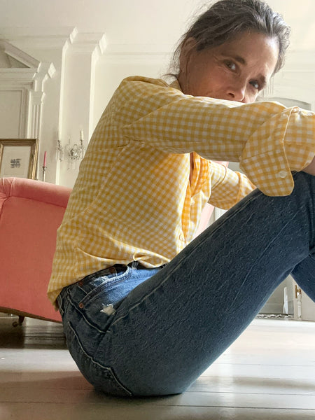 Ann at home in a yellow gingham Tomboy Popover and an indigo pair of jeans.