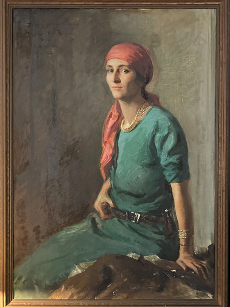 The portrait of Lucy Ferguson that hangs in the Greyfield Inn. She has on a red headscarf and a long green dress cinched with a belt.