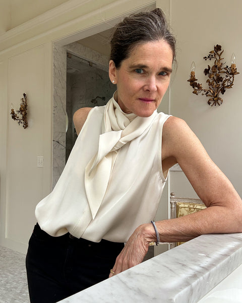 Ann at home in an ivory silk tie-neck blouse.