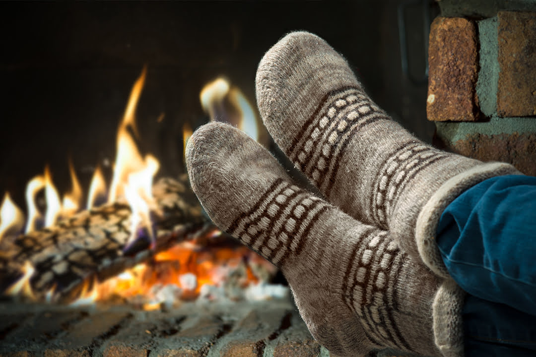 Woman wearing socks by a winter fire