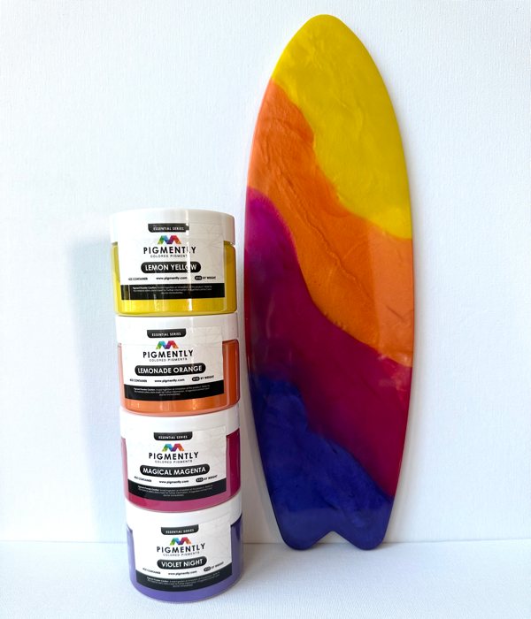A decorative resin art piece shaped like a surfboard, made using epoxy resin and the pictured Pigmently Pigments.