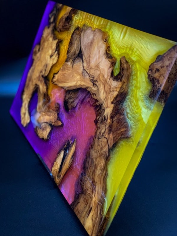 An epoxy resin tray, made using epoxy resin, trimmed chunks of wood, and the Neon Purple and Neon Yellow Pigments by Pigmently.
