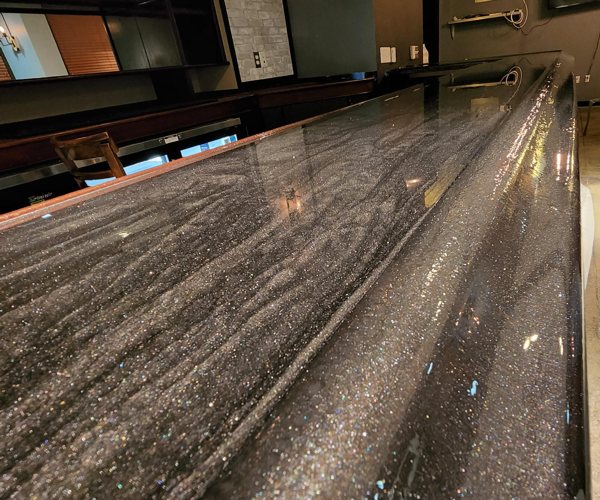 An epoxy bar top made using epoxy and Pigmently's Silver Glitter and Dark Matter mica powder pigments.