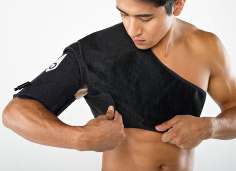 Man attaching the velcro on the shoulder wrap