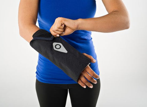 Woman attaching the velcro for the wrist wrap