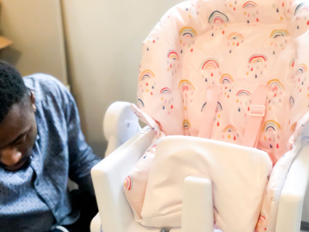 Image of Haley's husband helping to set up the Snax highchair.