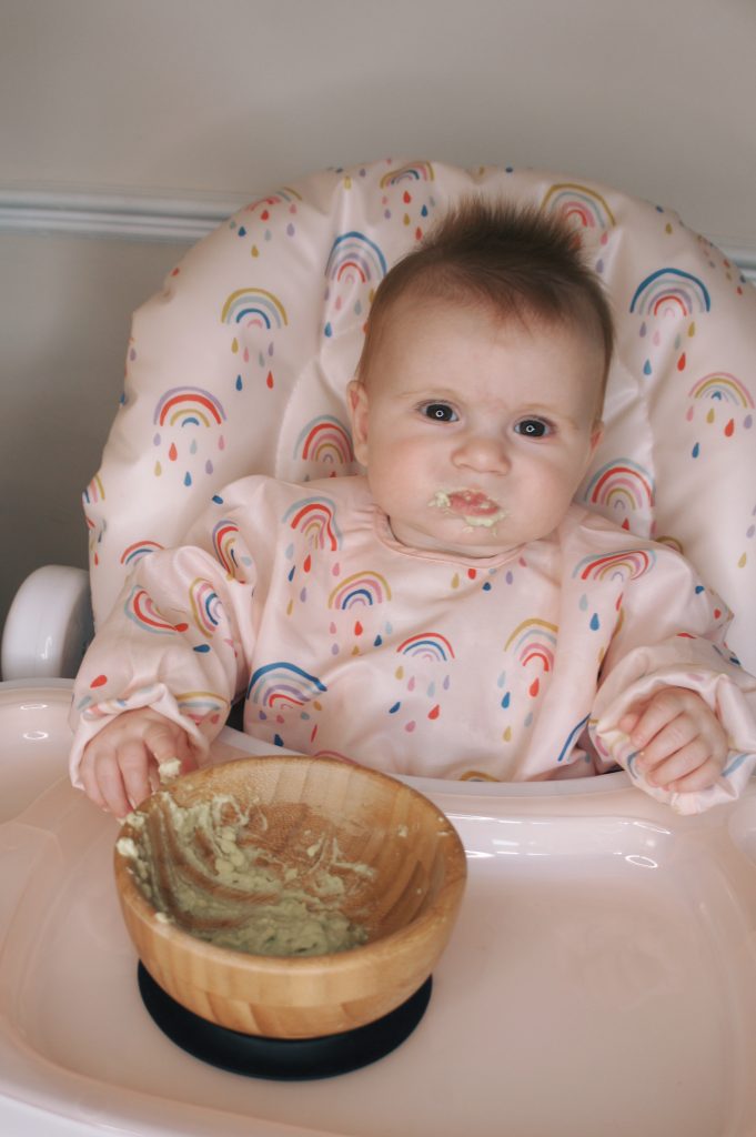 Overhead image of baby Posey feeding in the Snax highchair