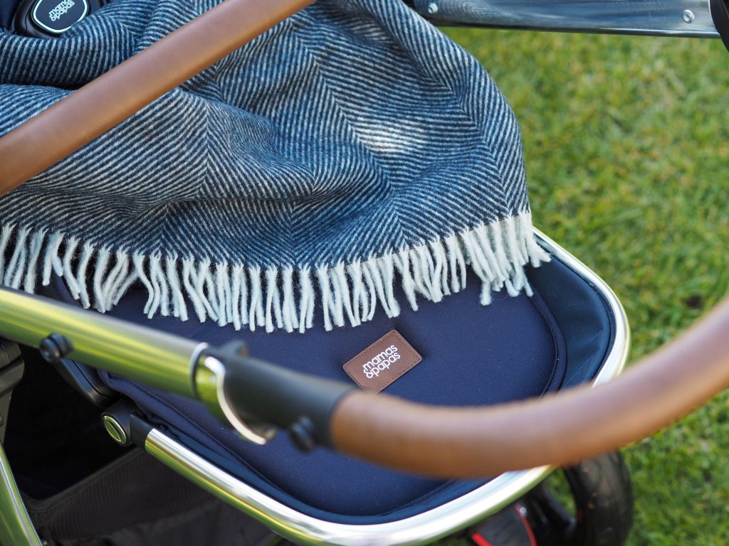 Close up of the Ocarro Moon's leatherette pushchair handle. 