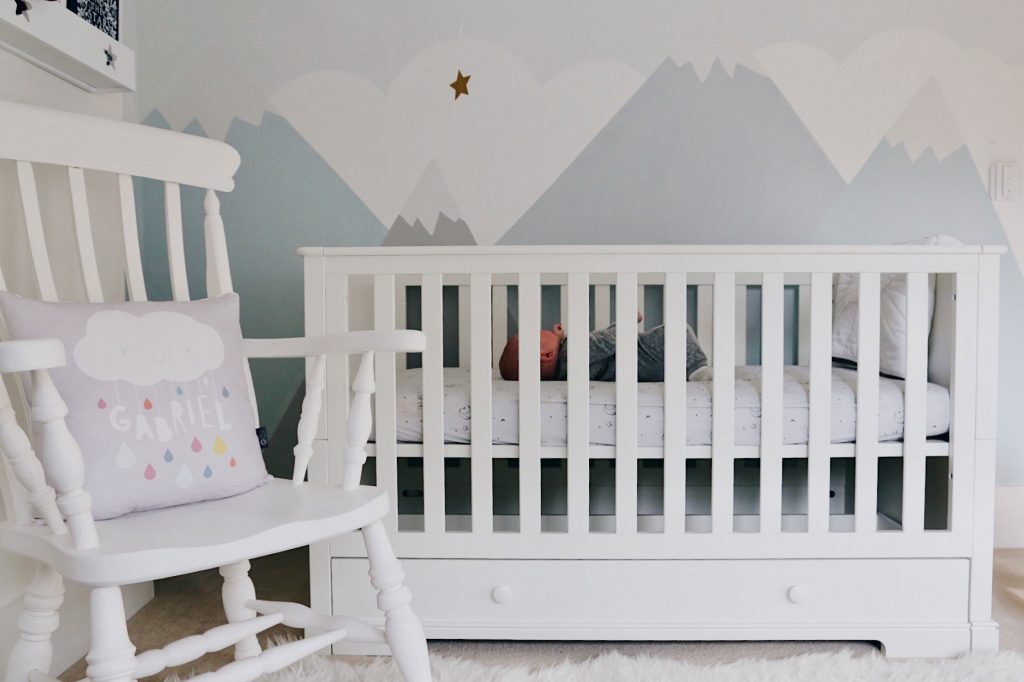 Cot bed and Bedding review - image of baby Gabriel in the cotbed, in a brightly lit nursery