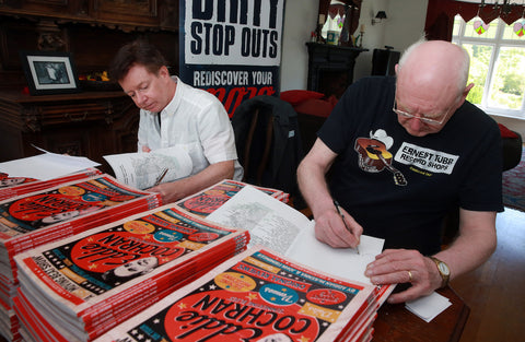 Adrian McKenna (left) and John Firminger sign copies of the book