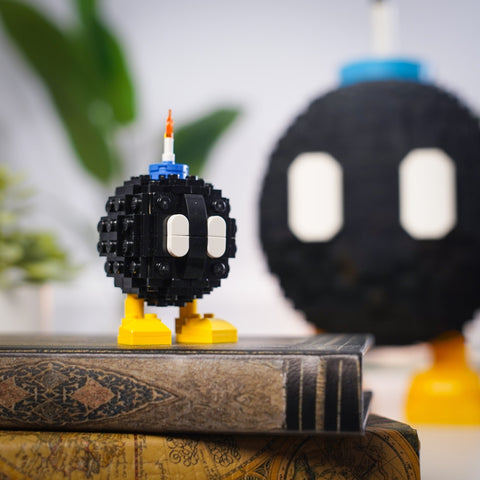 Mini Angry Bomb with Angry Bomb in background (both made of LEGO® bricks)