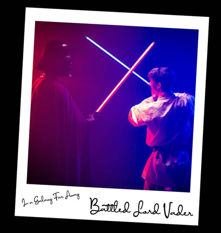 Dark Lord Vader and Luke cosplayer battling with sabers made of LEGO® bricks