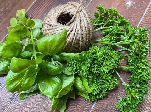 image of herbs and yarn ready to start drying on a wooden table
