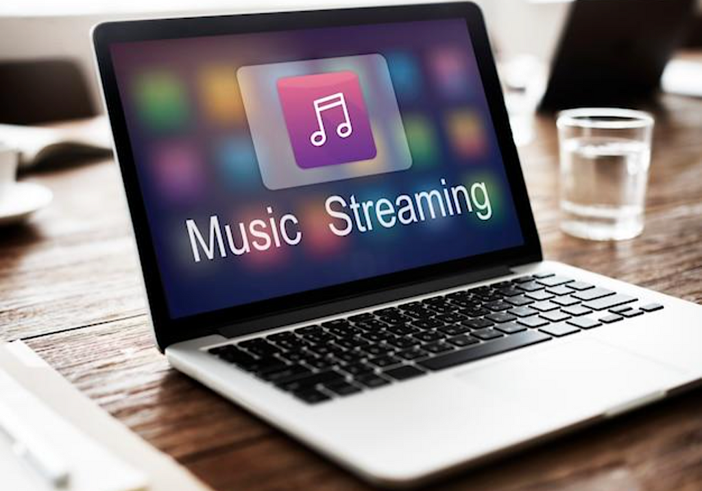 MacbookPro on desk streaming apple music