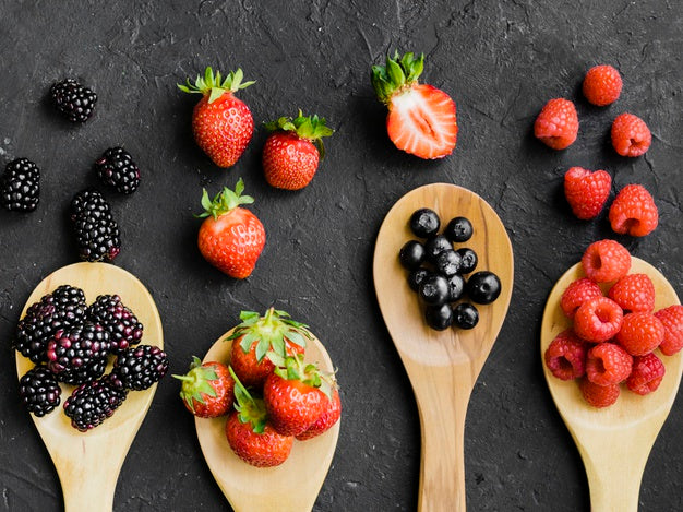 Berries on wooden spoons Free Photo