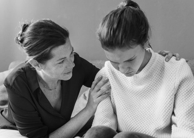 Mother consoling her sad daughter Free Photo