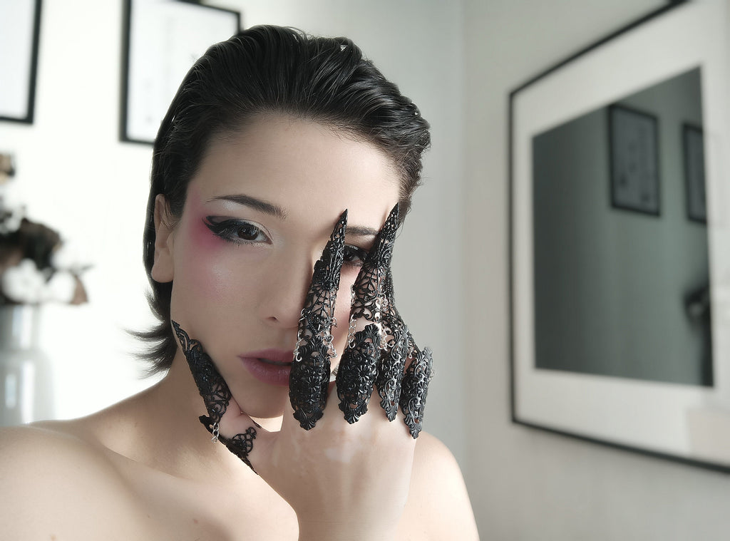 woman wearing black full finger claw rings