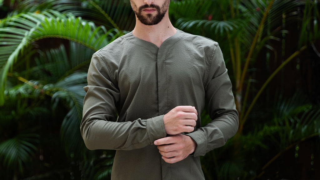 Man wearing Cheegs SeerTech™ Seersucker Long Sleeve in Khaki in a tropical setting
