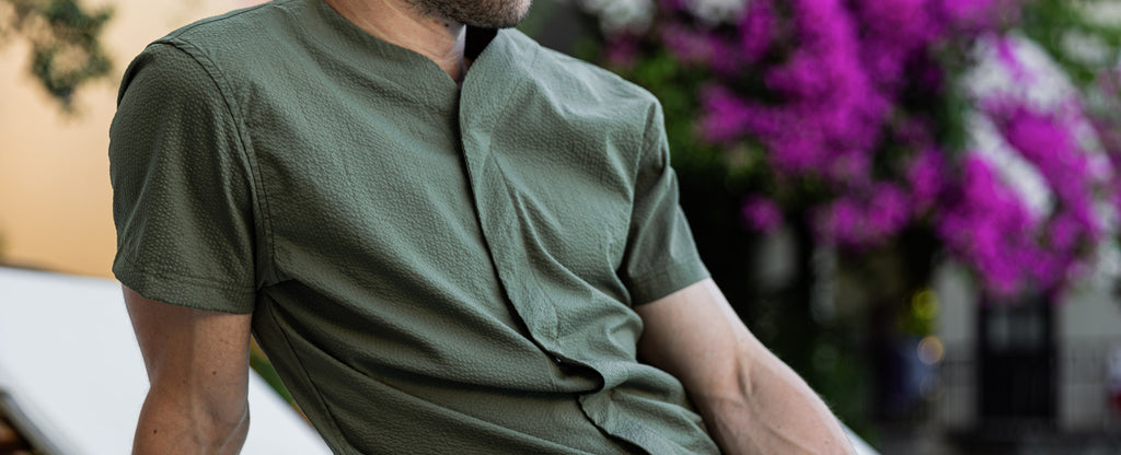 Close up of the Cheegs Collarless Future SeerTech Short Sleeve worn by a man on a sun chair. 