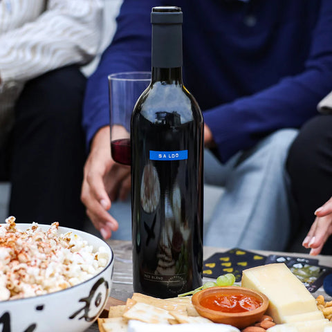 SALDO wine on a table with popcorn and friends.