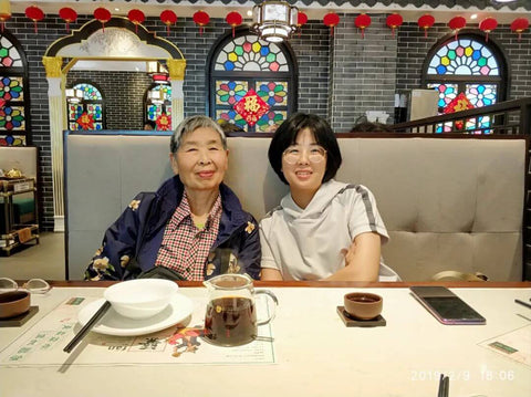 Yushan and her grandmother in a restaurant