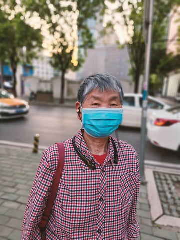 Yushan grandmother wearing Kite 2 and a face mask