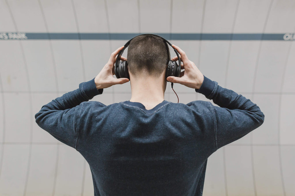 Man listening to music and possibly damaging his hearing