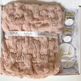 Soft luxe faux fur blanket in blush - coasters with gold writing - two small coffee creamer bombs - All are home - Taylor Lee Comfort