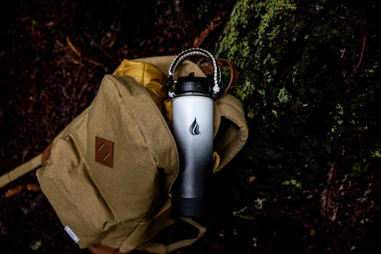 A Hydro Cell water bottle inside a brown backpack