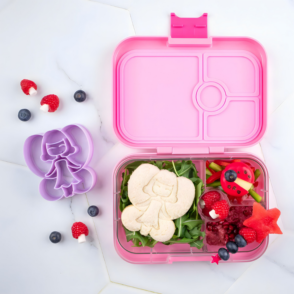 Yumbox MiniSnack snack box filled with fresh fruit and a bit of chocolate.