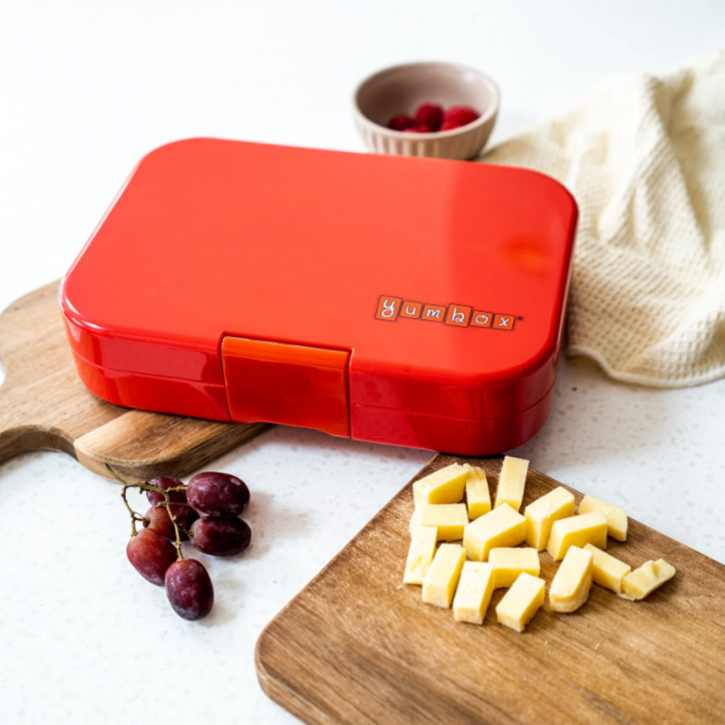 Yumbox MiniSnack snack box filled with fresh fruit and a bit of chocolate.