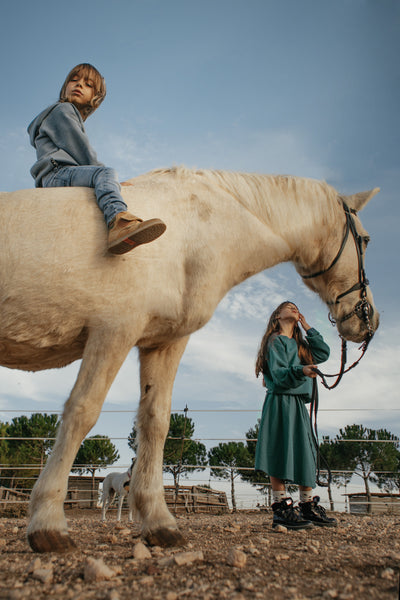 boy and girl in lmn3 organic cotton top 19 with white horse