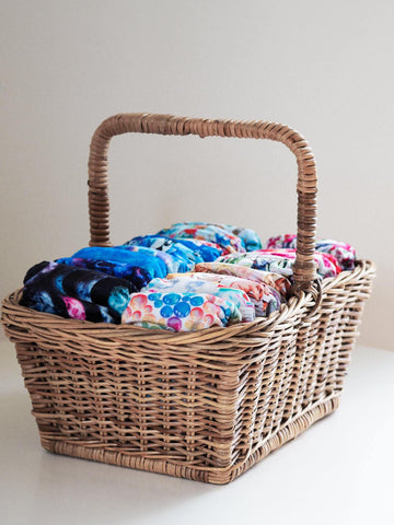 Quality cloth nappies neatly stacked in a basket ready for use