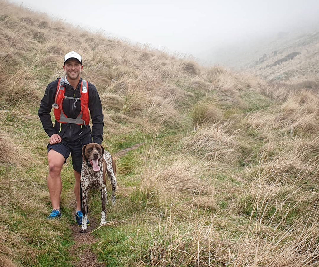 conrad with a dog in the mist on a trail