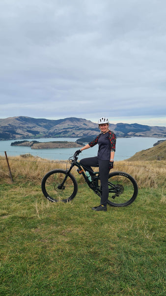 woman on mountain bike overlooking a bay