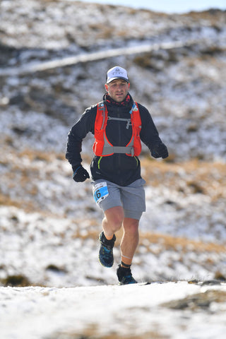 Man Running on a snowy hillside