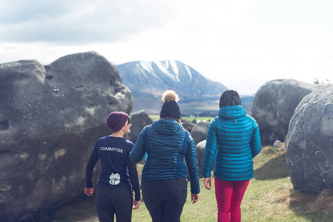 Three Women Walking Towards Mountains