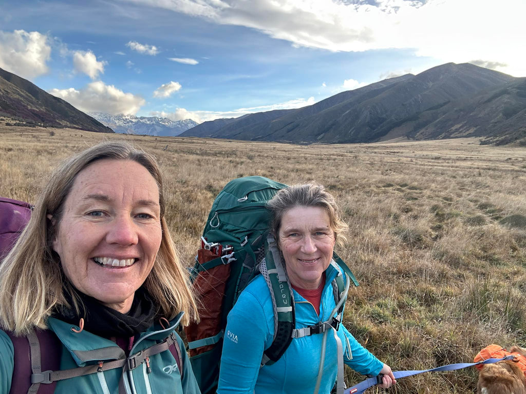 selfie of two women with mountains behind them