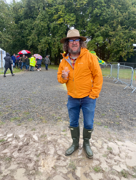 Man wearing a rainjacket at an outdoor food festival
