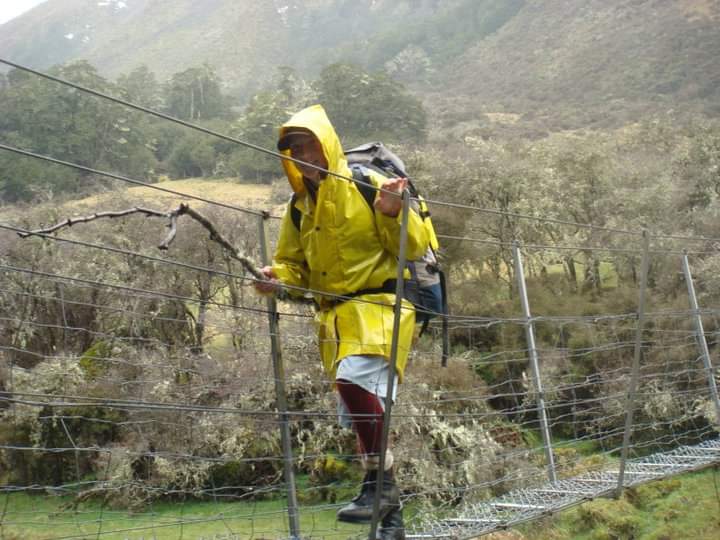 Child on a bridge with a yellow jacket