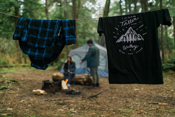 two shirts hanging on a campsite clothesline