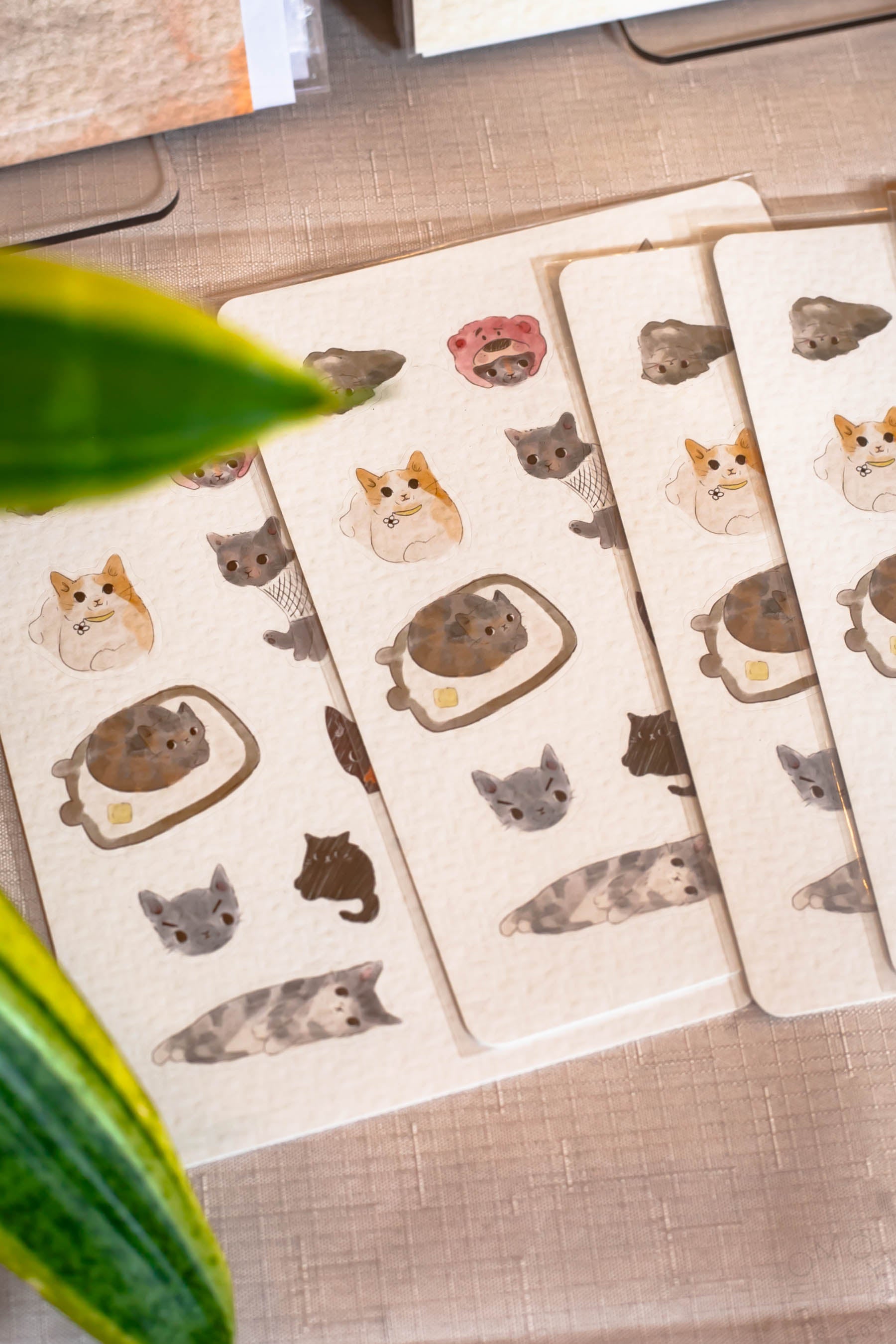Hannah made sticker sheets of the CATS OF OMOI based on a collage of staff cat photos that sits right behind our counter. Did you get one?!