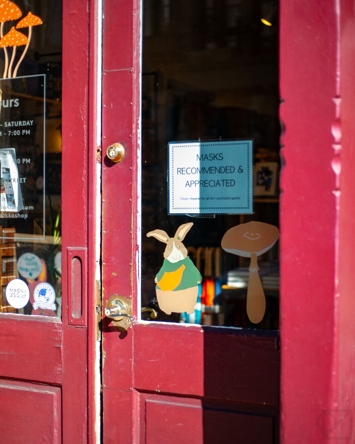 Madeleine Conover artwork for Omoi's front window features mushrooms of all kinds, plus plants and fuzzy friends