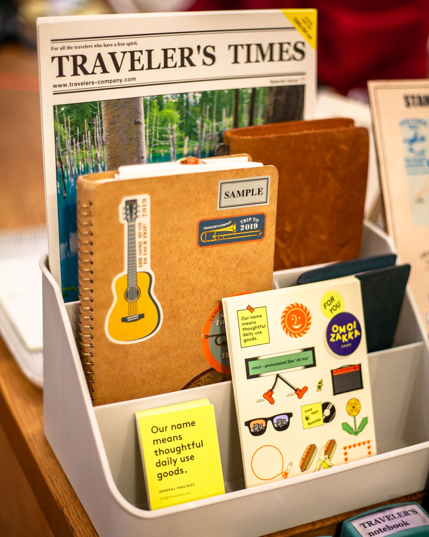 Stamp Caravan set up by the register, featuring our shop postcard and TRAVELER'S print newsletter