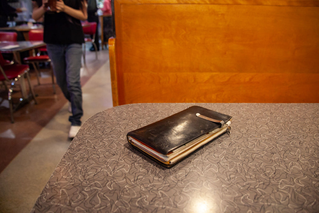 Our online director's TRAVELER'S notebook sitting atop the booth's retro tabletop 